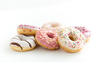 Image showing close up of glazed donuts on white table