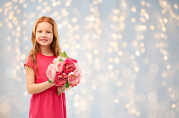 Image showing happy red haired girl with flowers over lights