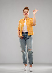 Image showing happy red haired teenage girl showing ok hand sign