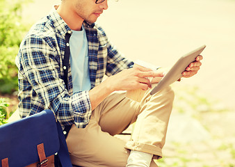 Image showing man with tablet pc and coffee on city street bench