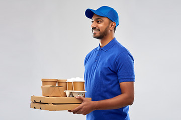 Image showing happy indian delivery man with food and drinks