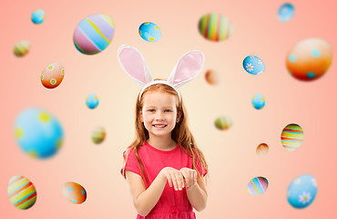 Image showing happy red haired girl wearing easter bunny ears