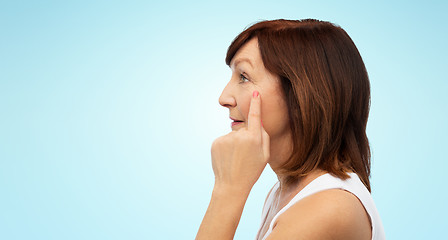 Image showing profile of senior woman pointing to eye wrinkles