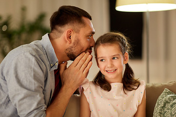 Image showing happy father whispering secret to daughter at home