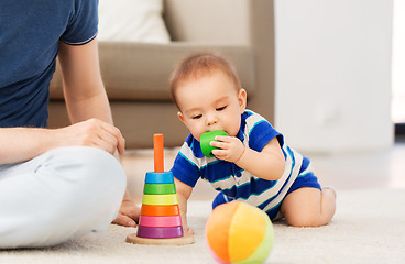 Image showing baby boy with father and pyramid toy at home