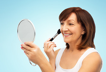 Image showing senior woman with mirror and make up blush brush