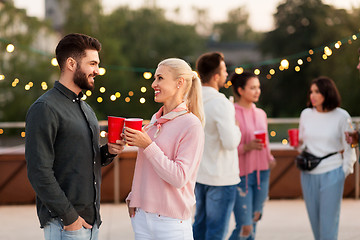 Image showing friends with drinks in party cups at rooftop