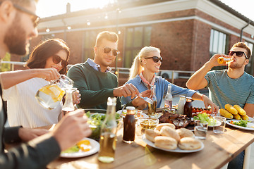 Image showing friends having dinner or bbq party on rooftop