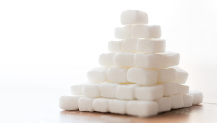 Image showing close up of white lump sugar pyramid on table