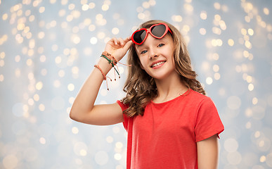 Image showing happy teenage girl in red heart shaped sunglasses