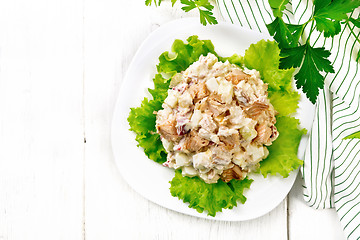 Image showing Salad of salmon and cucumber in plate on board top