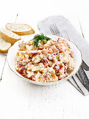 Image showing Salad with chicken and vegetables in plate on light wooden board