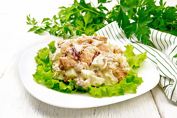 Image showing Salad of salmon and cucumber in plate on light board