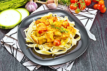 Image showing Pasta with goulash in plate on dark board