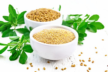 Image showing Fenugreek in two bowls with leaves on wooden board