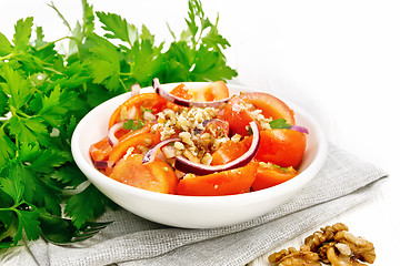 Image showing Salad with tomato and walnut in plate on board