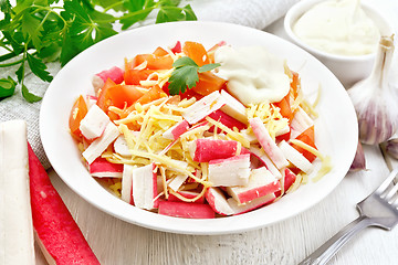 Image showing Salad of surimi and tomatoes on light board