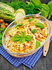 Image showing Zucchini baked with tomatoes in pan on napkin