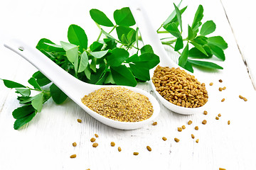 Image showing Fenugreek in two spoons with leaves on white board