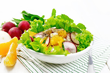 Image showing Salad of radish and orange with mint on white board