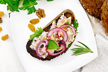 Image showing Bruschetta with fish and curd in plate on board top