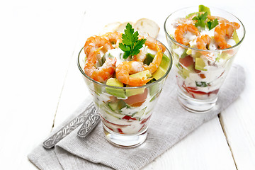 Image showing Salad with shrimp and avocado in two glasses on light board