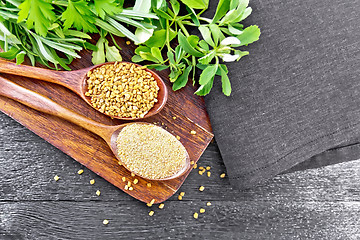 Image showing Fenugreek in two spoons with herbs on board top