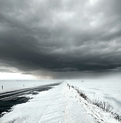 Image showing Stormy sky and snow road