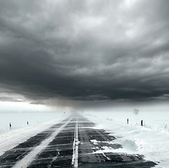 Image showing Stormy sky and snow road