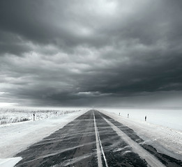 Image showing Stormy sky and snow road