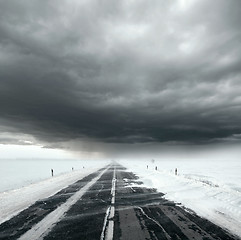 Image showing Stormy sky and snow road