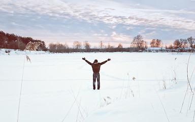 Image showing Traveller With His Arms Raised Enjoys The Winter Landscape