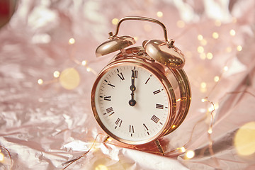 Image showing Christmas card with golden alarmclock and garland.