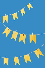 Image showing Yellow flags garland on a rope.