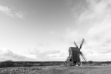 Image showing Open landscape with an old windmill in BW