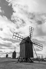 Image showing Old wooden windmills line up