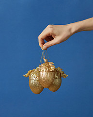 Image showing Woman hand with Christmas decoration.