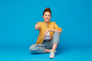 Image showing happy red haired teenage girl showing thumbs up