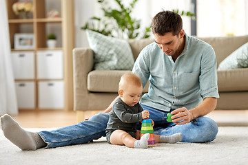 Image showing father playing with little baby daughter at home