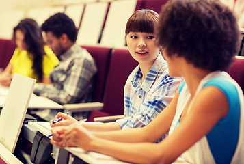 Image showing group of students talking in lecture hall