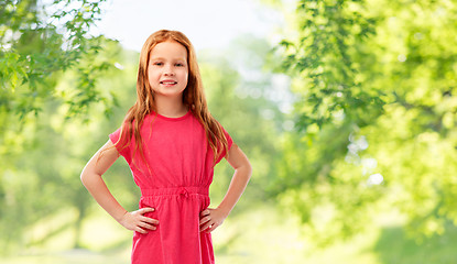 Image showing smiling red haired girl posing in pink dress