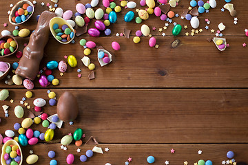 Image showing chocolate eggs, easter bunny and candies on wood