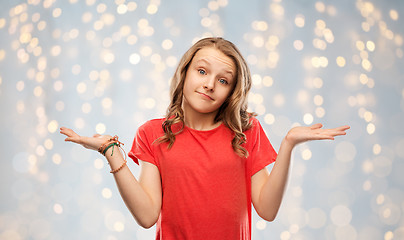 Image showing wondering teenage girl in red t-shirt shrugging