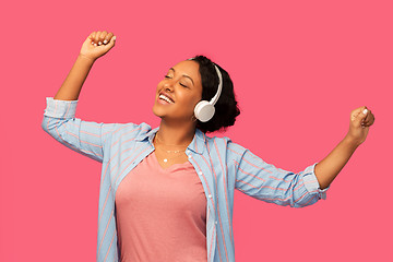 Image showing african woman in headphones listening to music