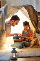 Image showing happy family playing with toy in kids tent at home