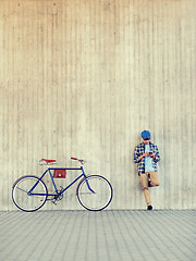 Image showing man with smartphone, earphones and bicycle