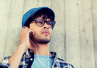 Image showing man with earphones listening to music on street