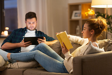 Image showing couple with tablet computer and book at home