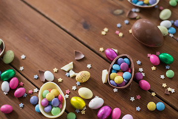 Image showing chocolate eggs and candy drops on wooden table