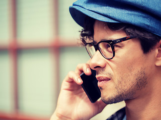 Image showing close up of man with smartphone calling on street